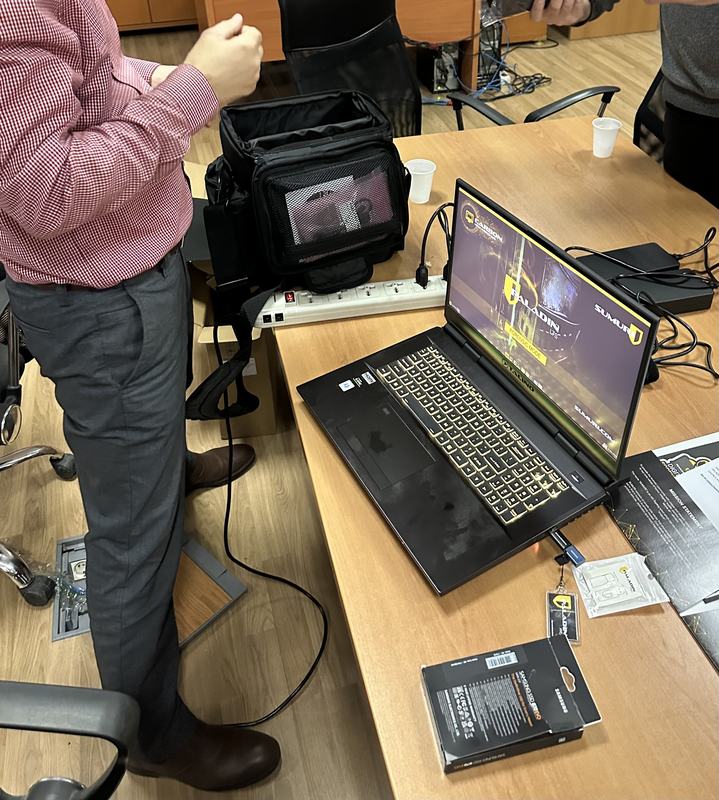 A portable forensic field kit and imaging laptop set up on a table